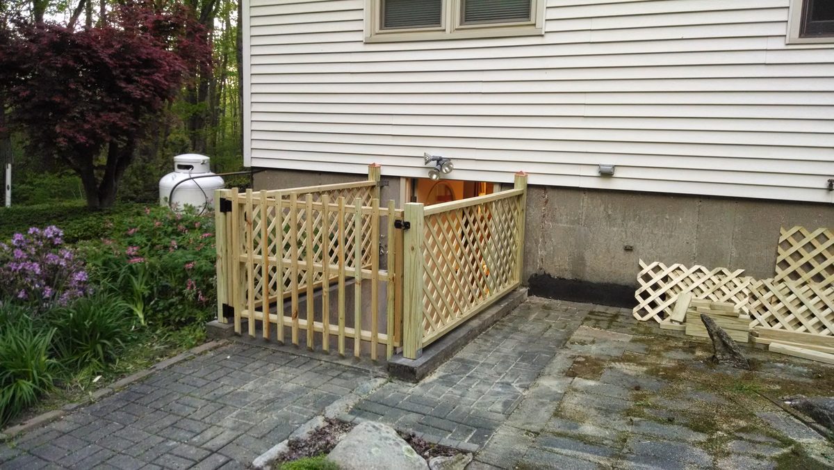 Custom carpentry lattice gate at basement entrance